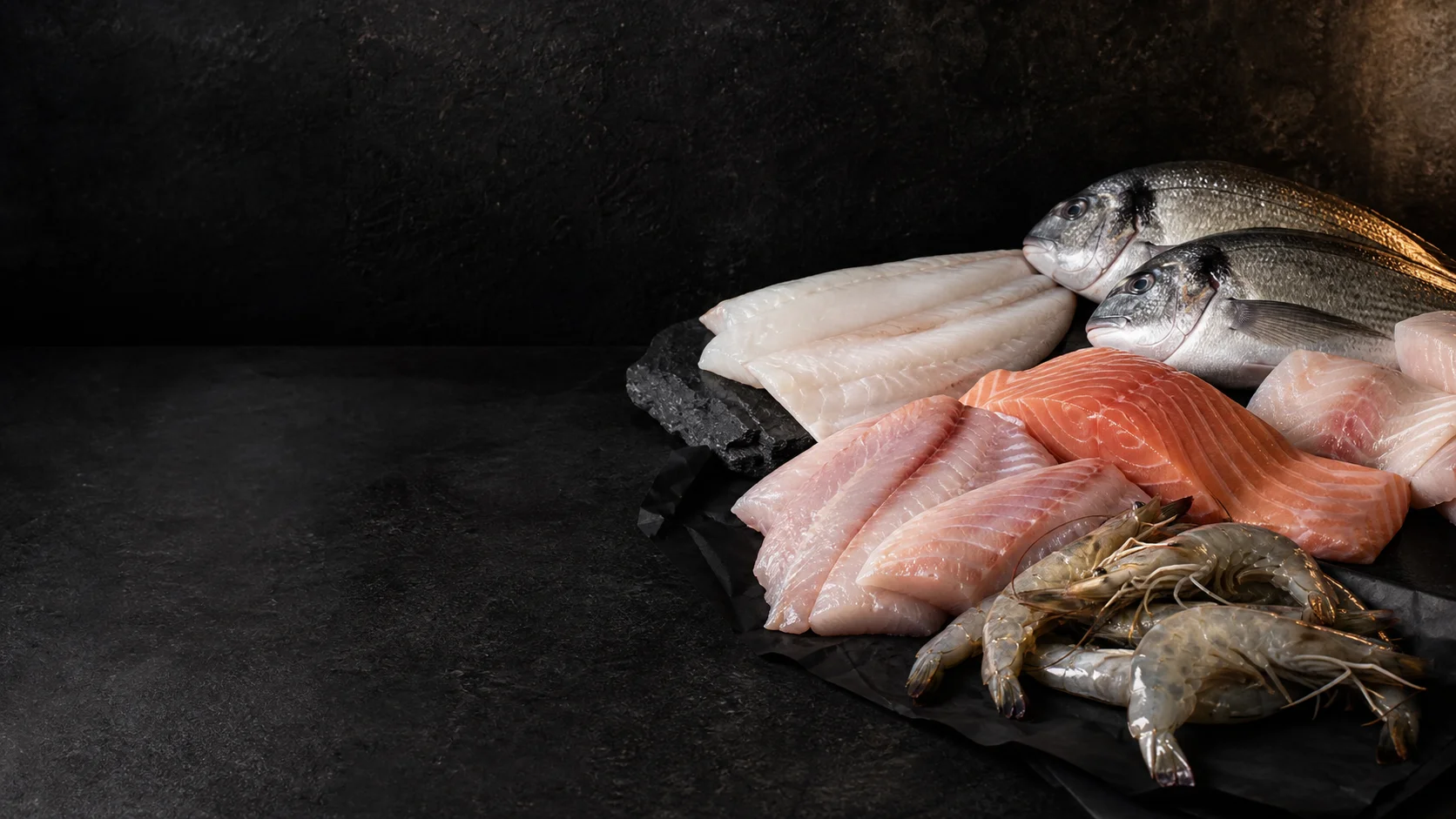 Fresh raw fish and seafood fillets prepared for home cooking
