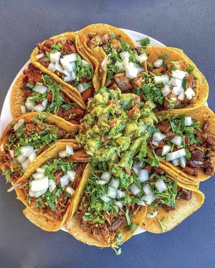 Assorted Mexican street tacos with guacamole