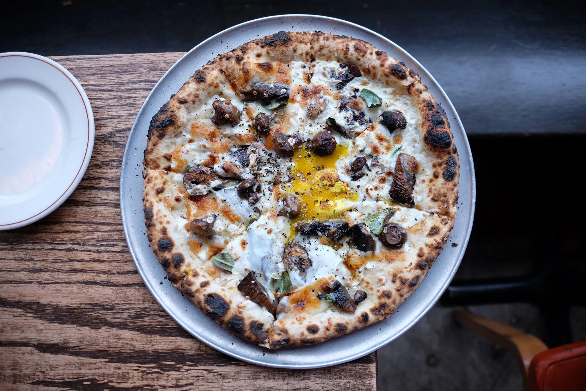 Wood-fired pizza with egg and mushrooms