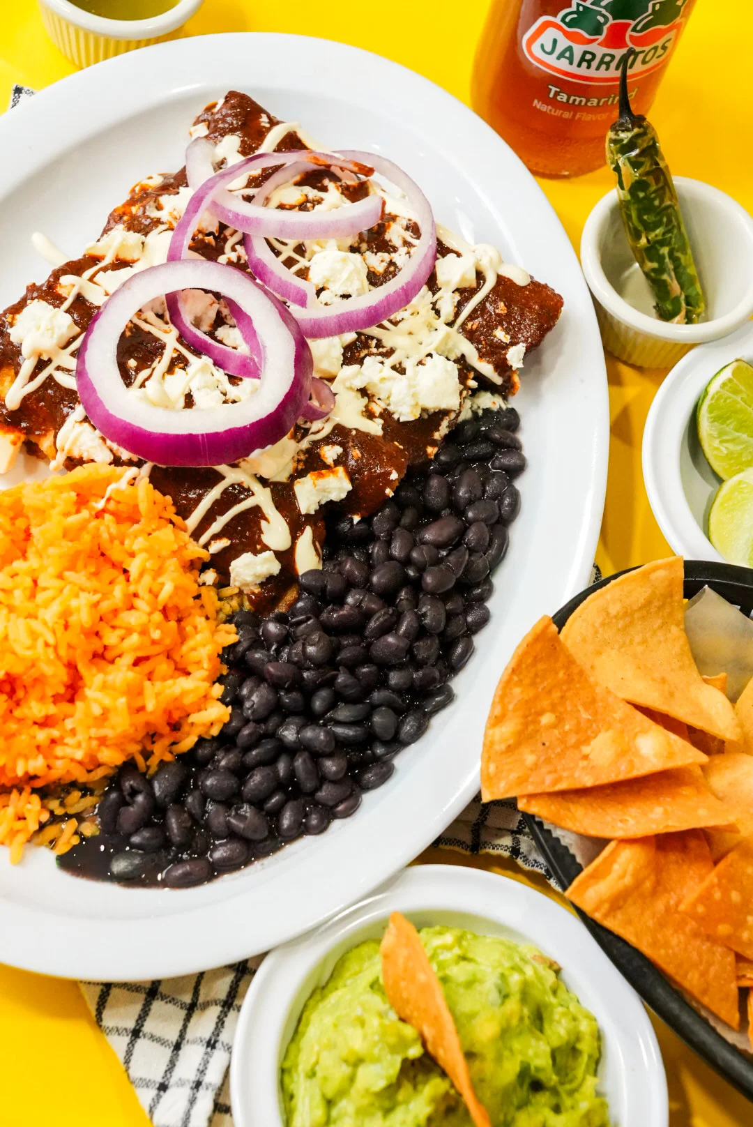 Plate of enchiladas with rice and beans, a classic Mexican dish