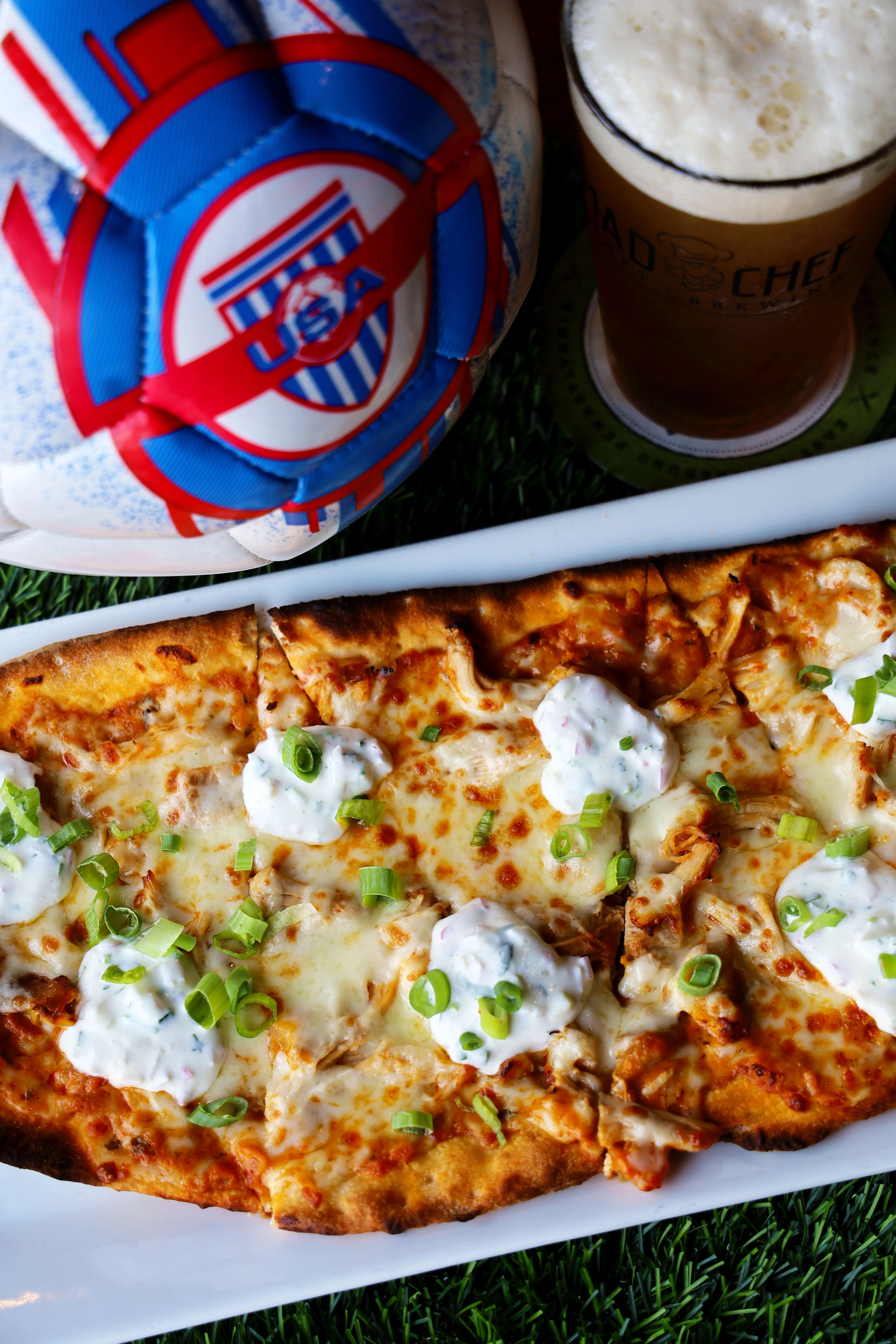 Delicious chicken broccoli Alfredo flatbread topped with cheese and herbs.