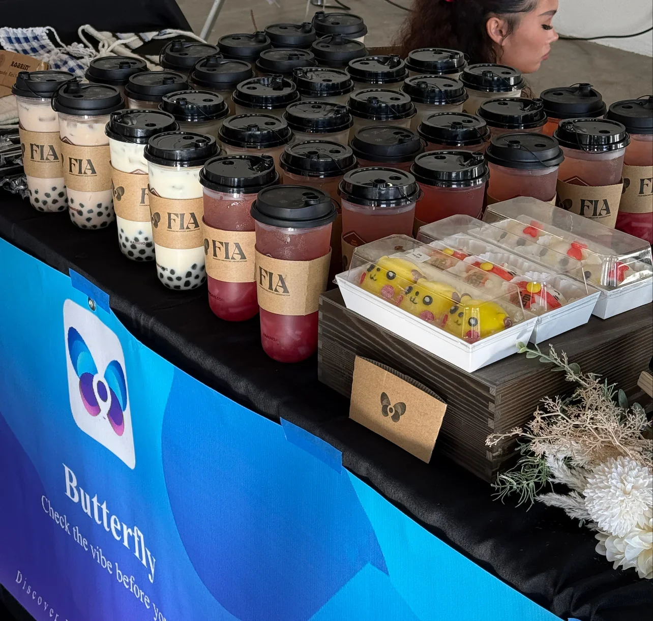 Colorful bubble tea drinks and desserts at a vibrant food stall
