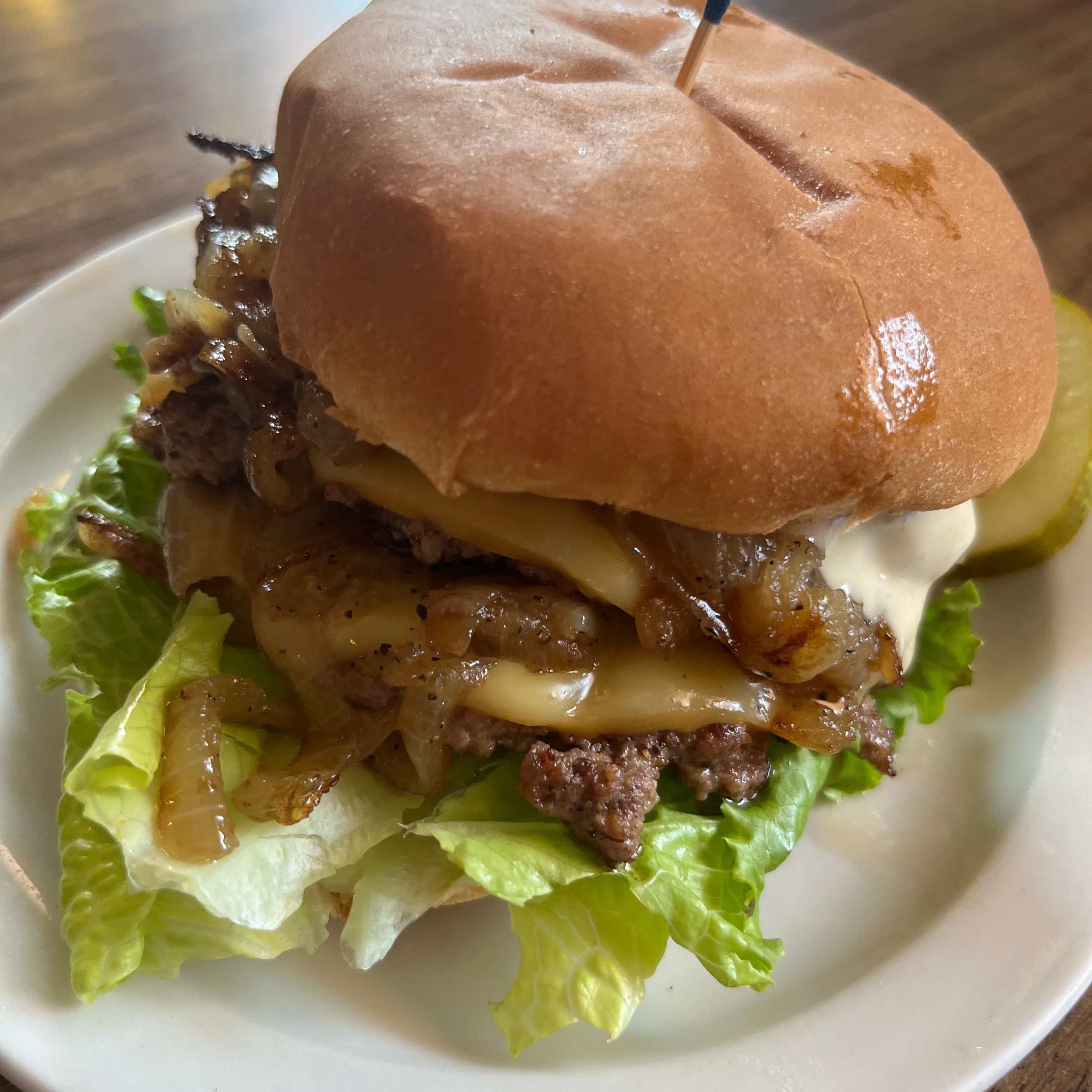 Classic American cheeseburger sandwich with pickles