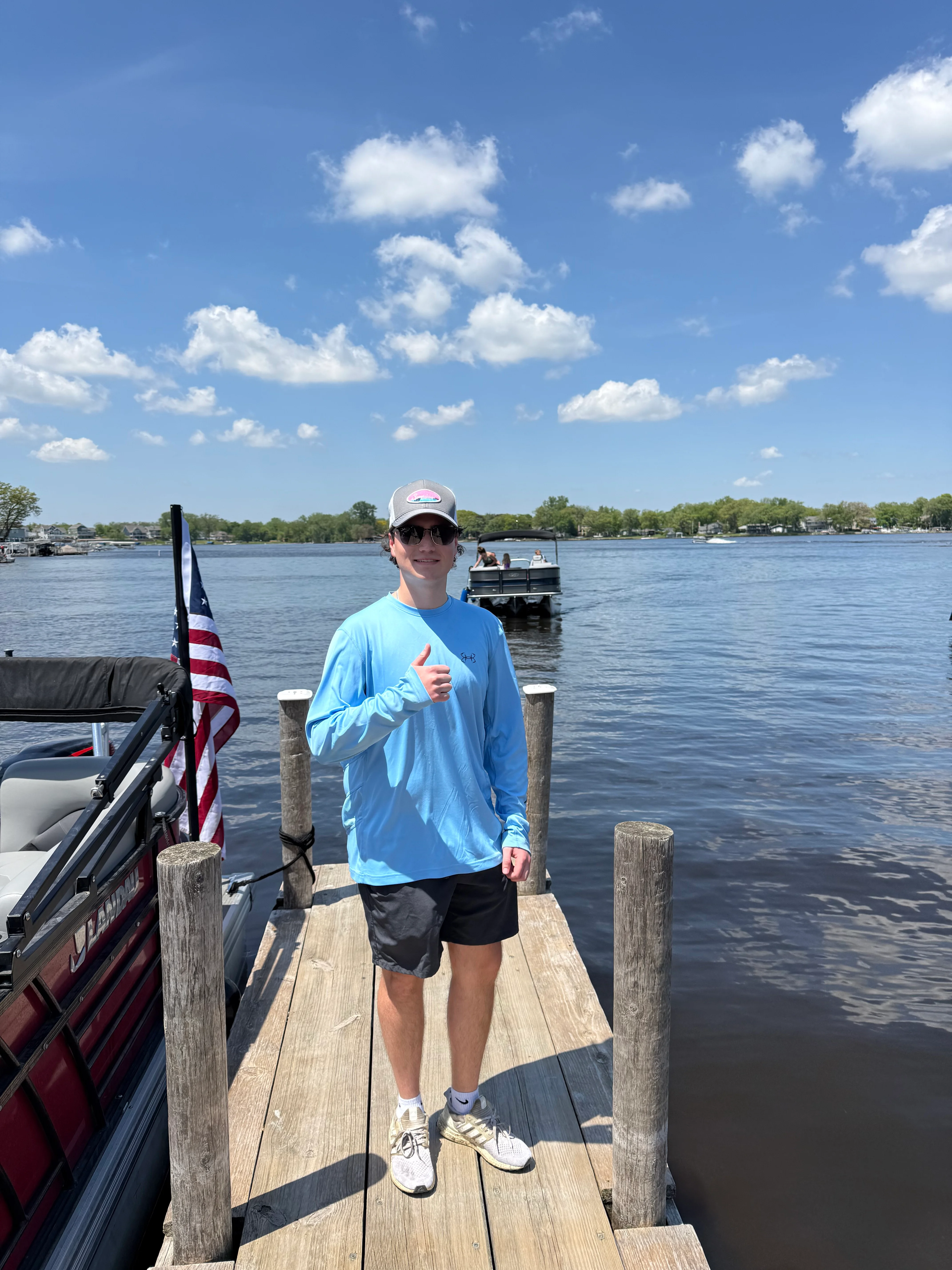 Guest standing on the Sunset Grill dock on Bluff Lake