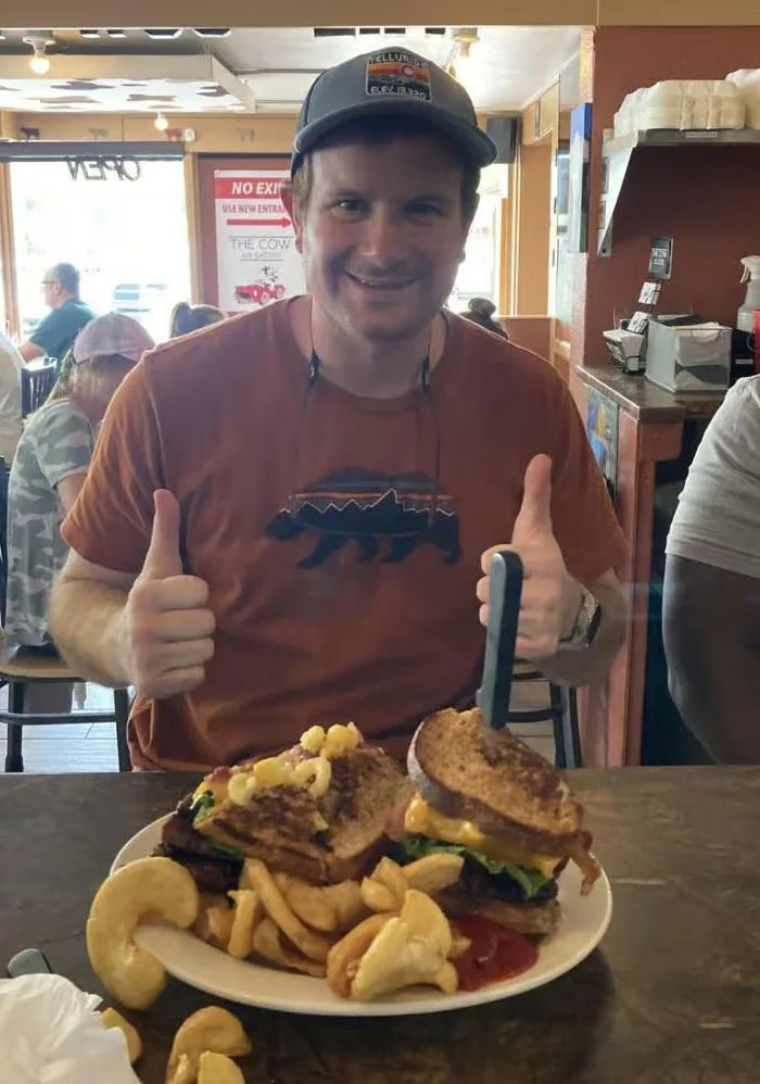 Giant cheeseburger with fries in a casual diner setting