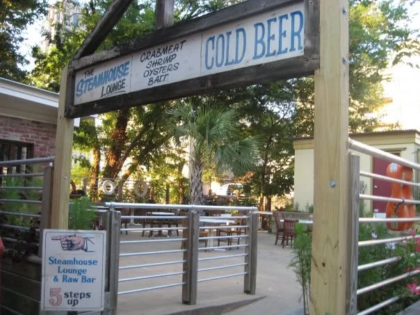 Entrance to a seafood lounge with outdoor seating and a bar