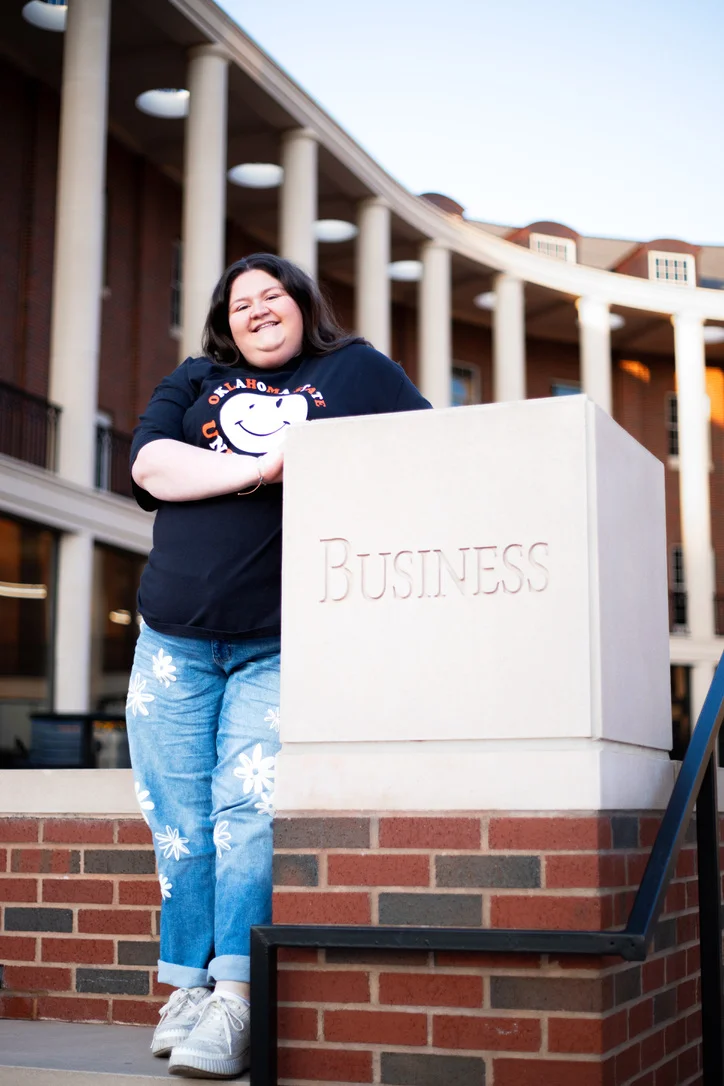 Student posing at a business school campus