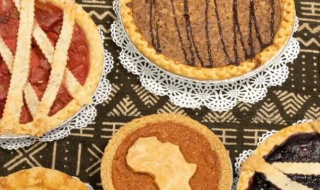 Assorted pies including sweet potato and fruit varieties on a decorative table