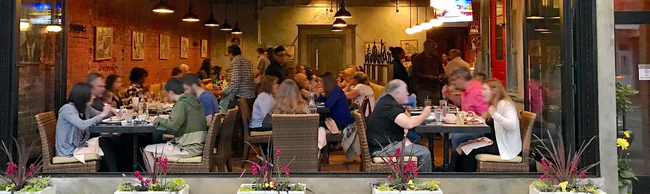 Cozy restaurant interior with diners enjoying meals and warm lighting