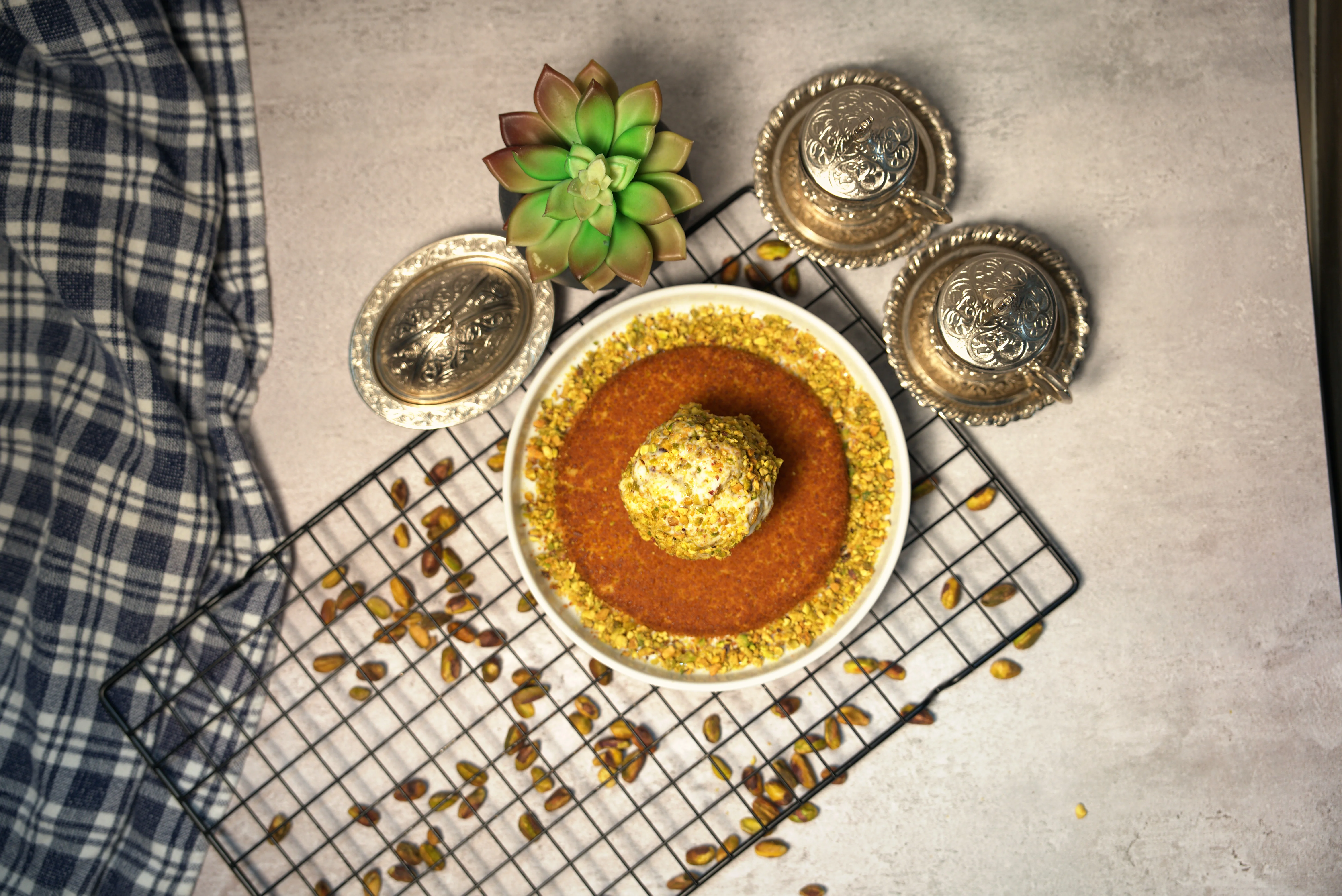 Assortment of Middle Eastern knafeh desserts with pistachios and cream