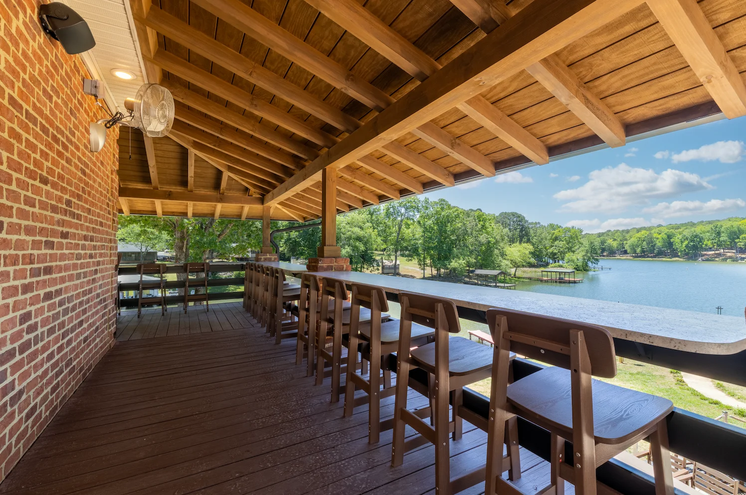 Outdoor seating area with a view of the lake and trees.
