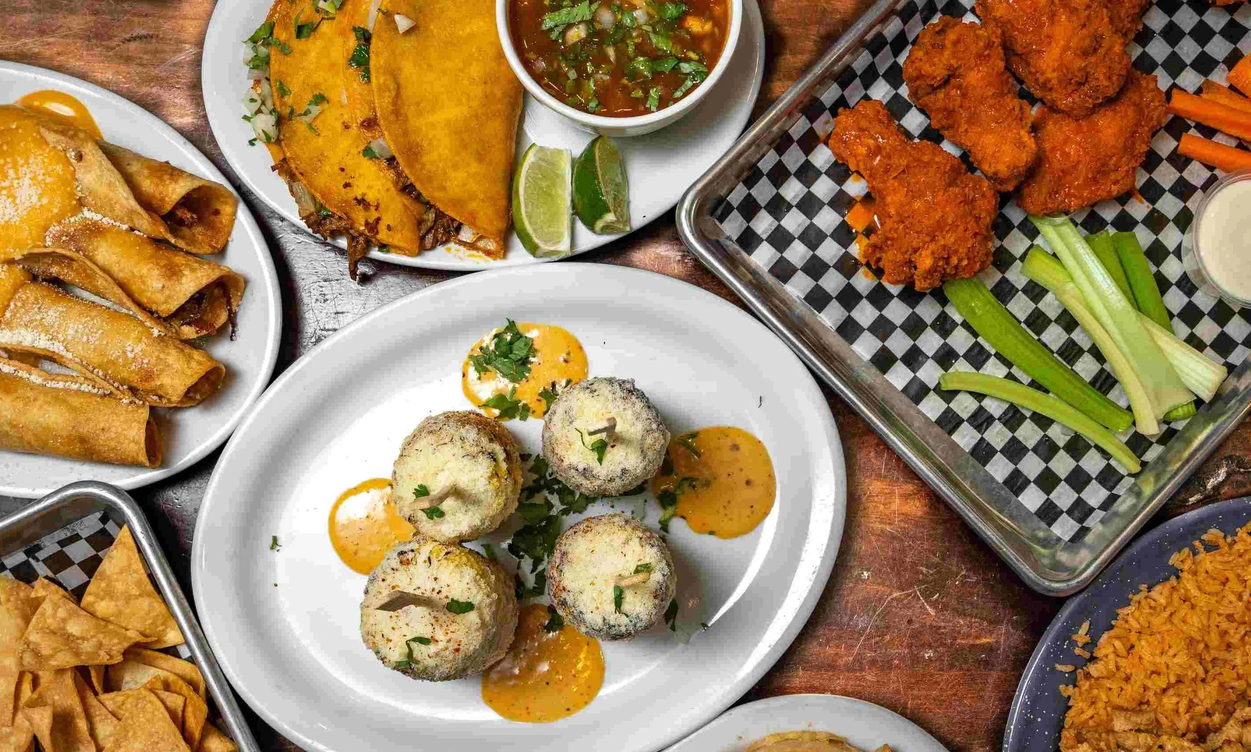 Assorted Mexican dishes including tacos and flautas