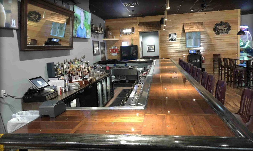 Modern bar counter with a variety of spirits and seating