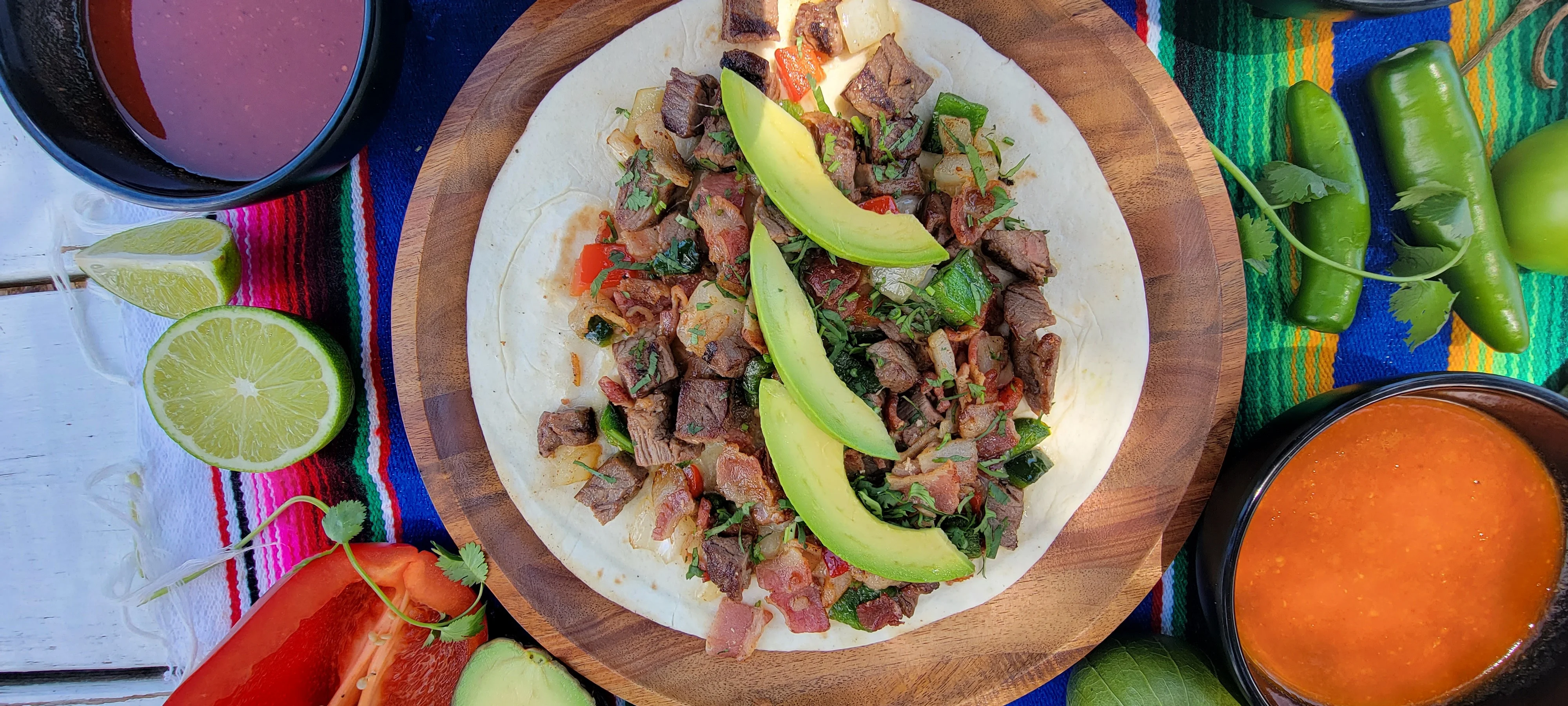 Delicious Mexican carne asada taco with avocado slices