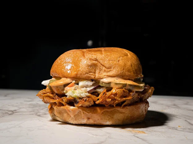 Delicious sandwich with fresh ingredients on a wooden table.