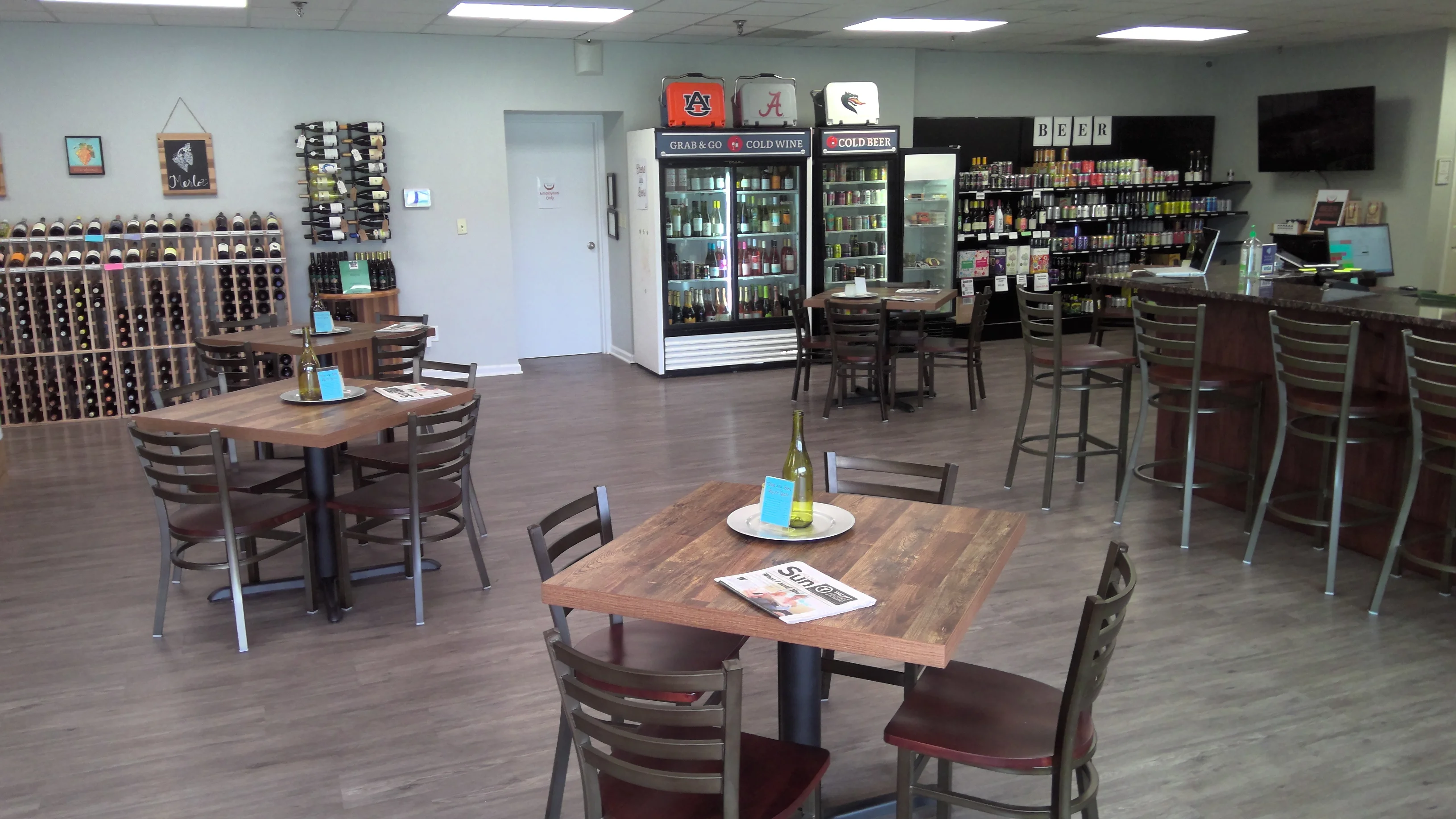 Cozy restaurant interior with wine display and seating area