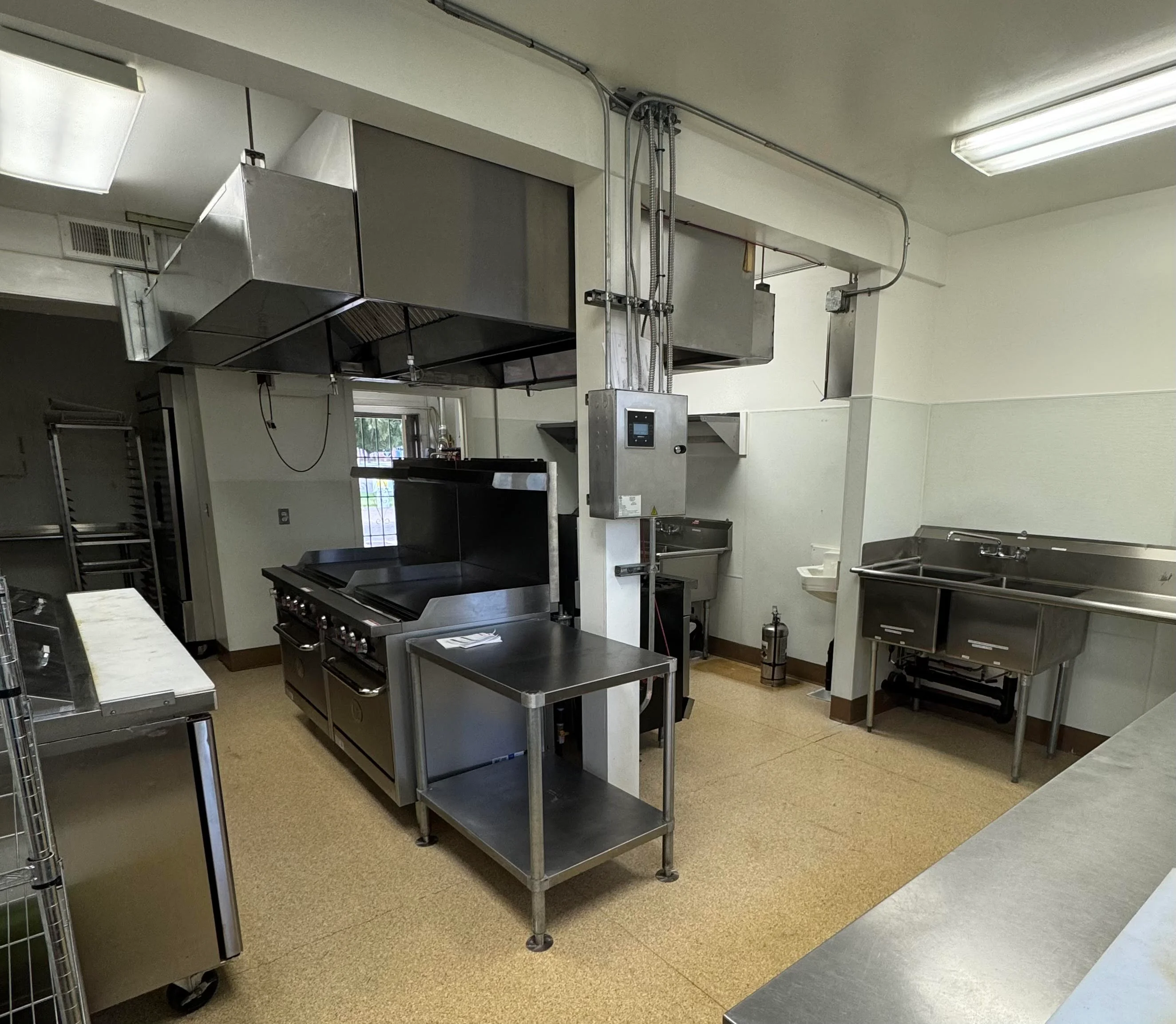 Modern commercial kitchen with stainless steel equipment