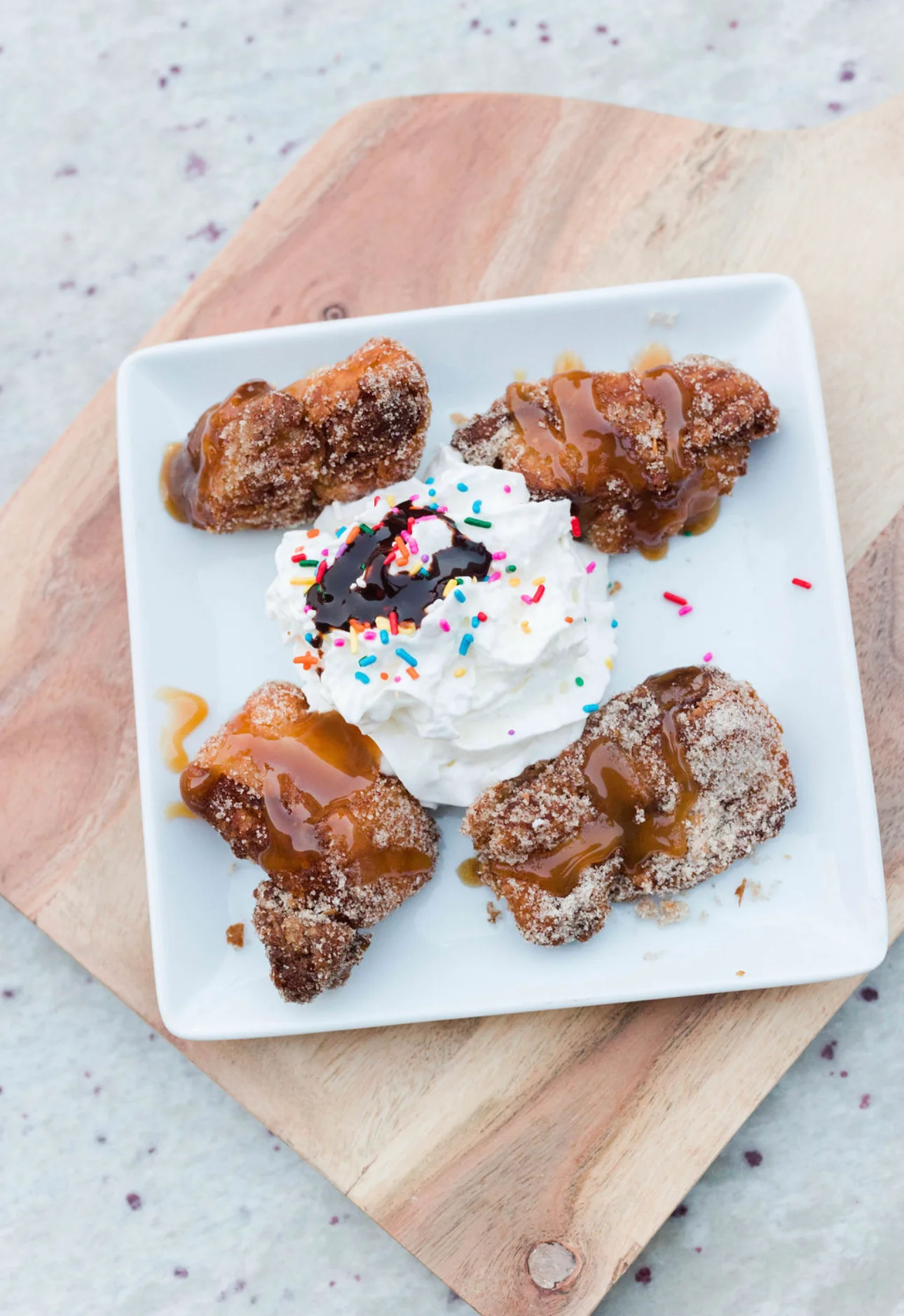 Delicious churros with whipped cream and chocolate sauce