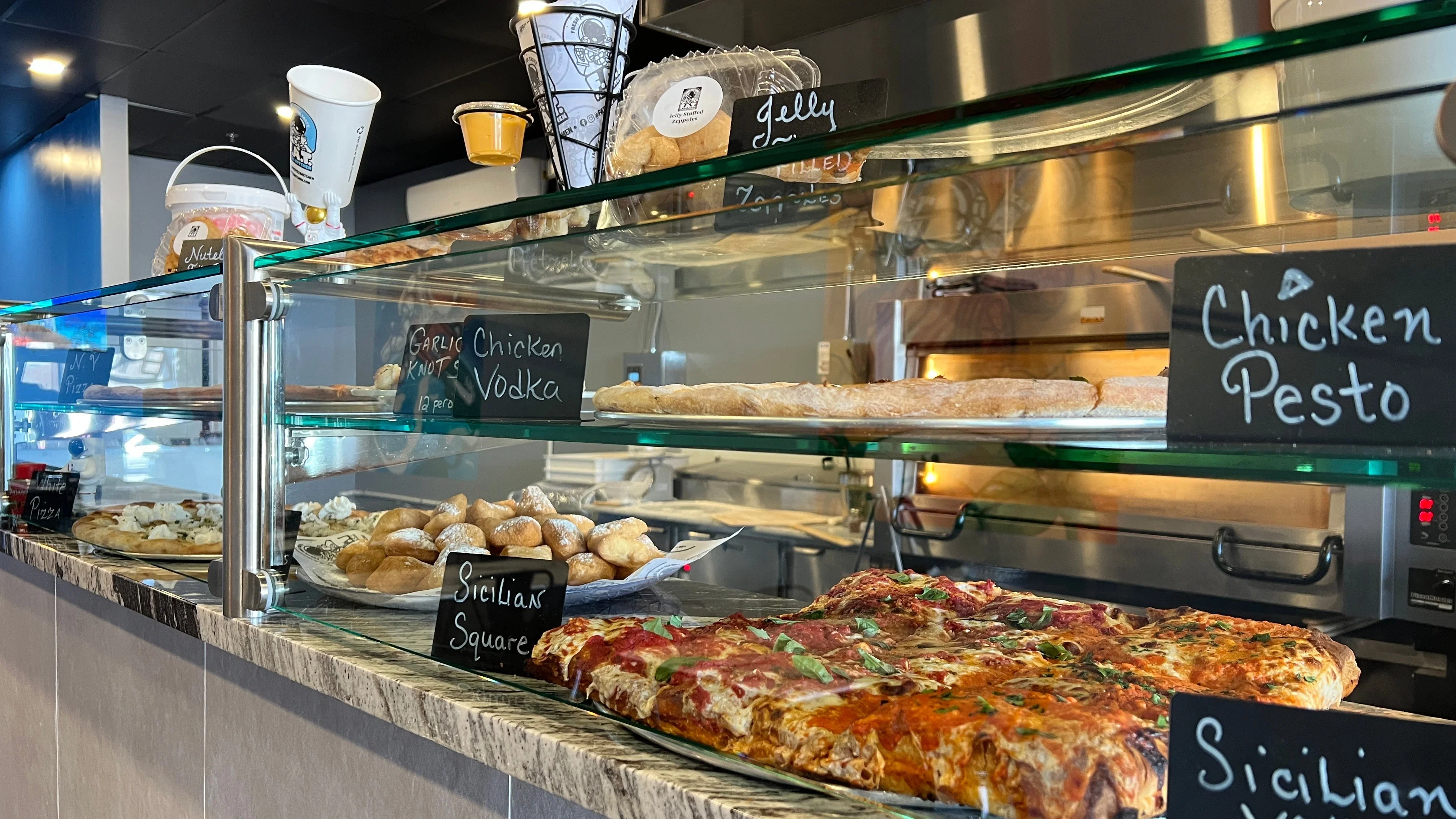 Sicilian pizza and Italian pastries displayed in a restaurant