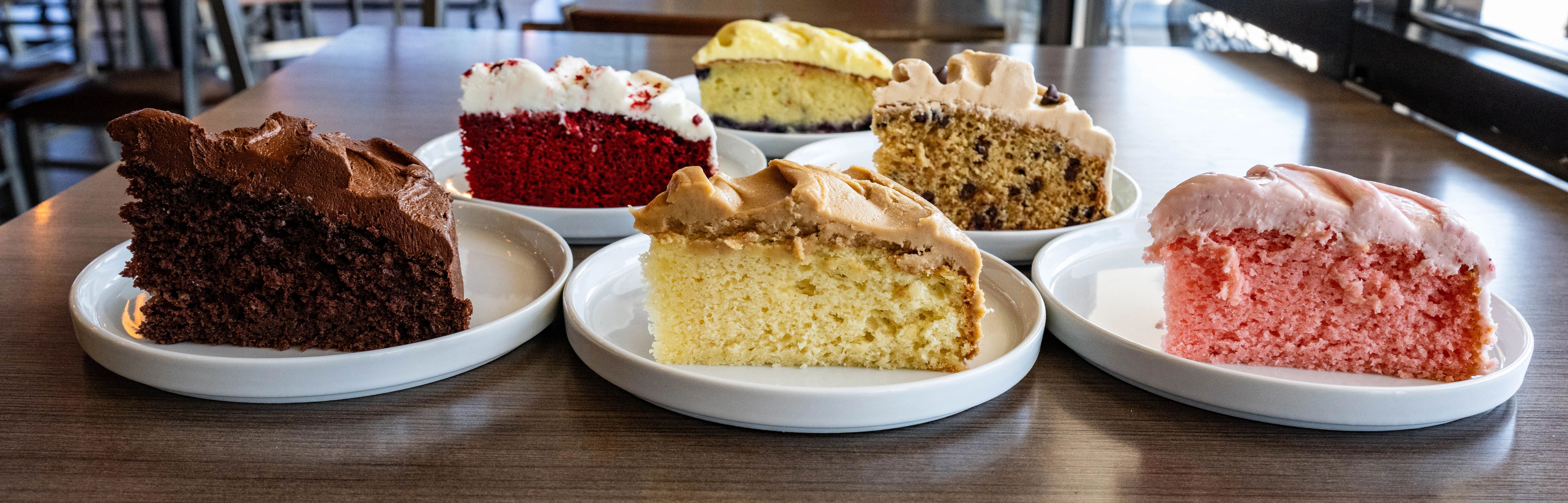 Slice of classic vanilla cake with creamy frosting