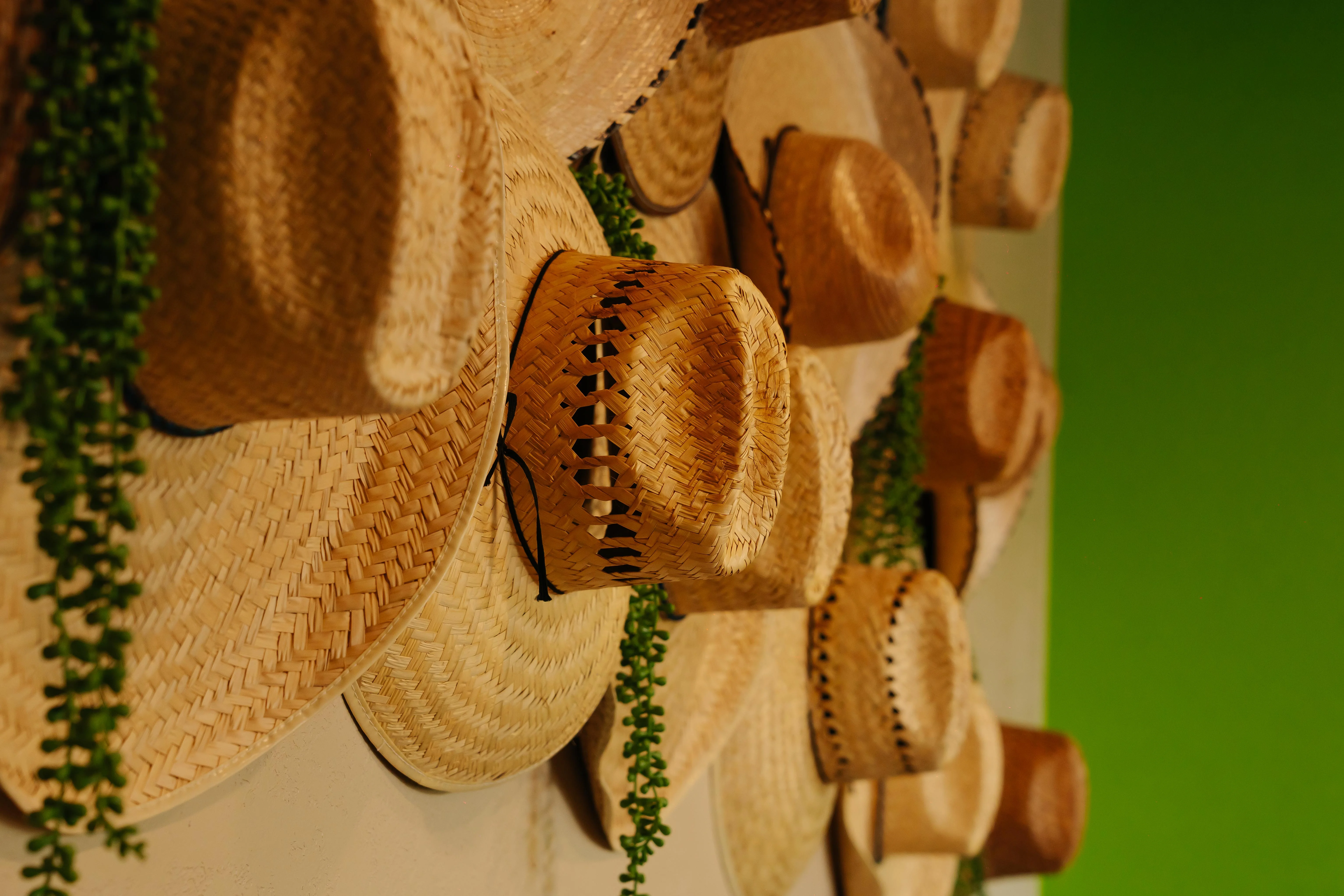 Decorative wall of woven straw hats in a vibrant restaurant setting