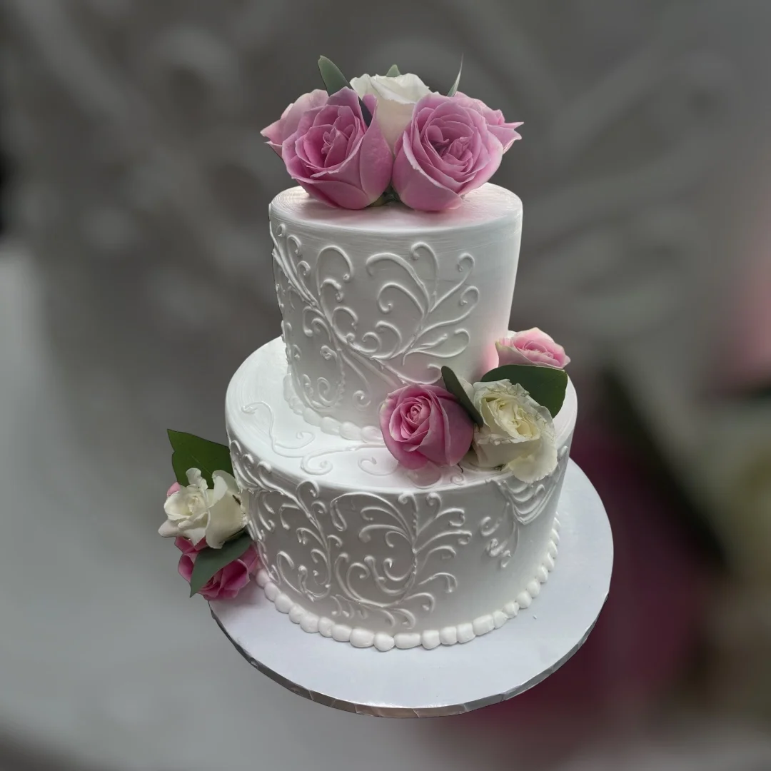 Elegant two-tier wedding cake with pink roses