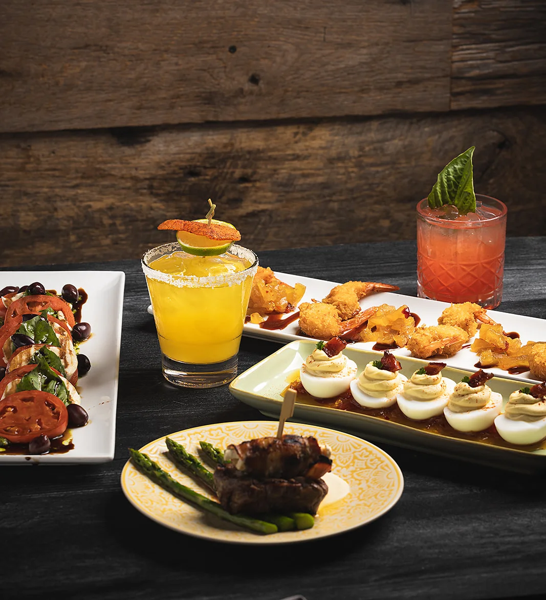 Assorted appetizers and cocktails in a rustic setting
