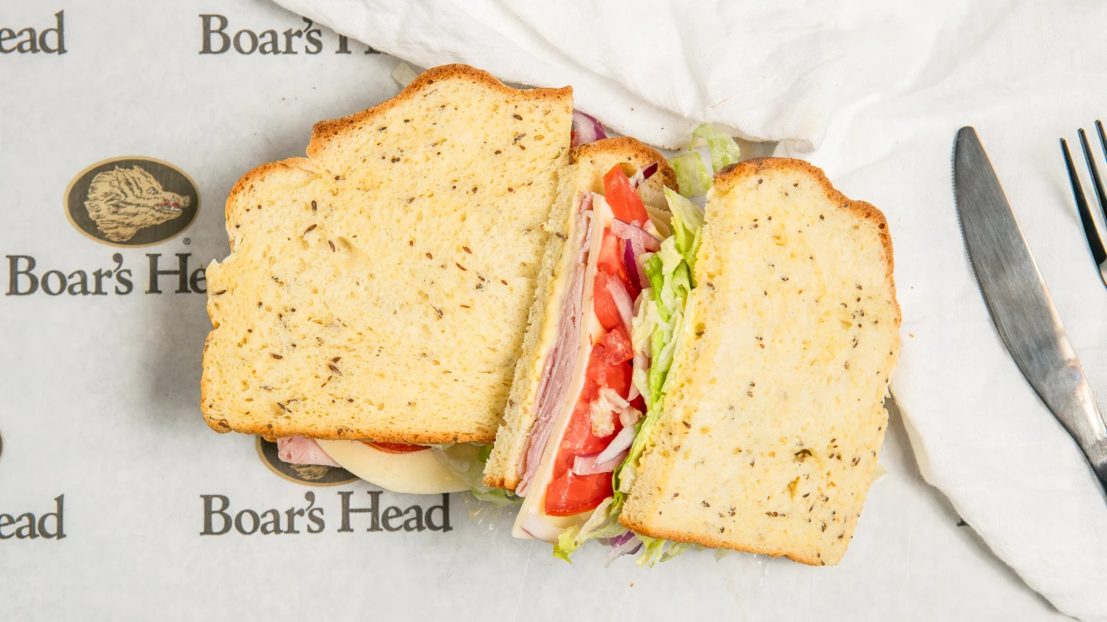 Classic deli sandwich on rye bread with fresh vegetables