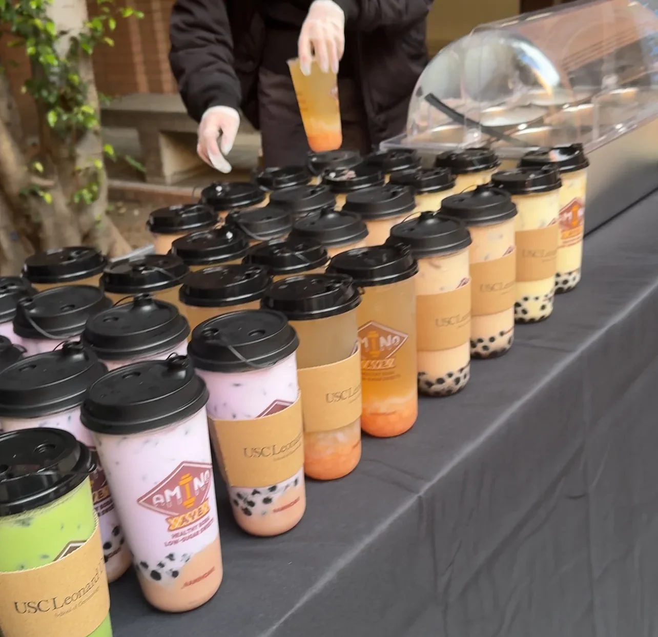 Colorful bubble tea drinks on display at an event