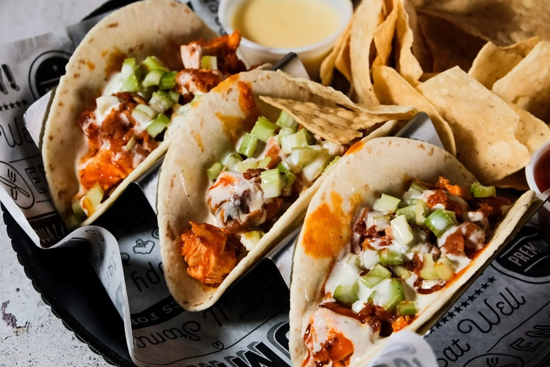 Crispy fish tacos topped with creamy sauce and cabbage