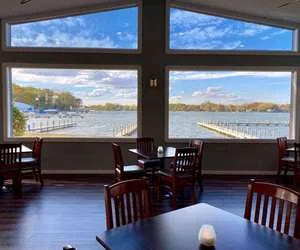 Dining room tables by the big windows looking out over Bluff Lake