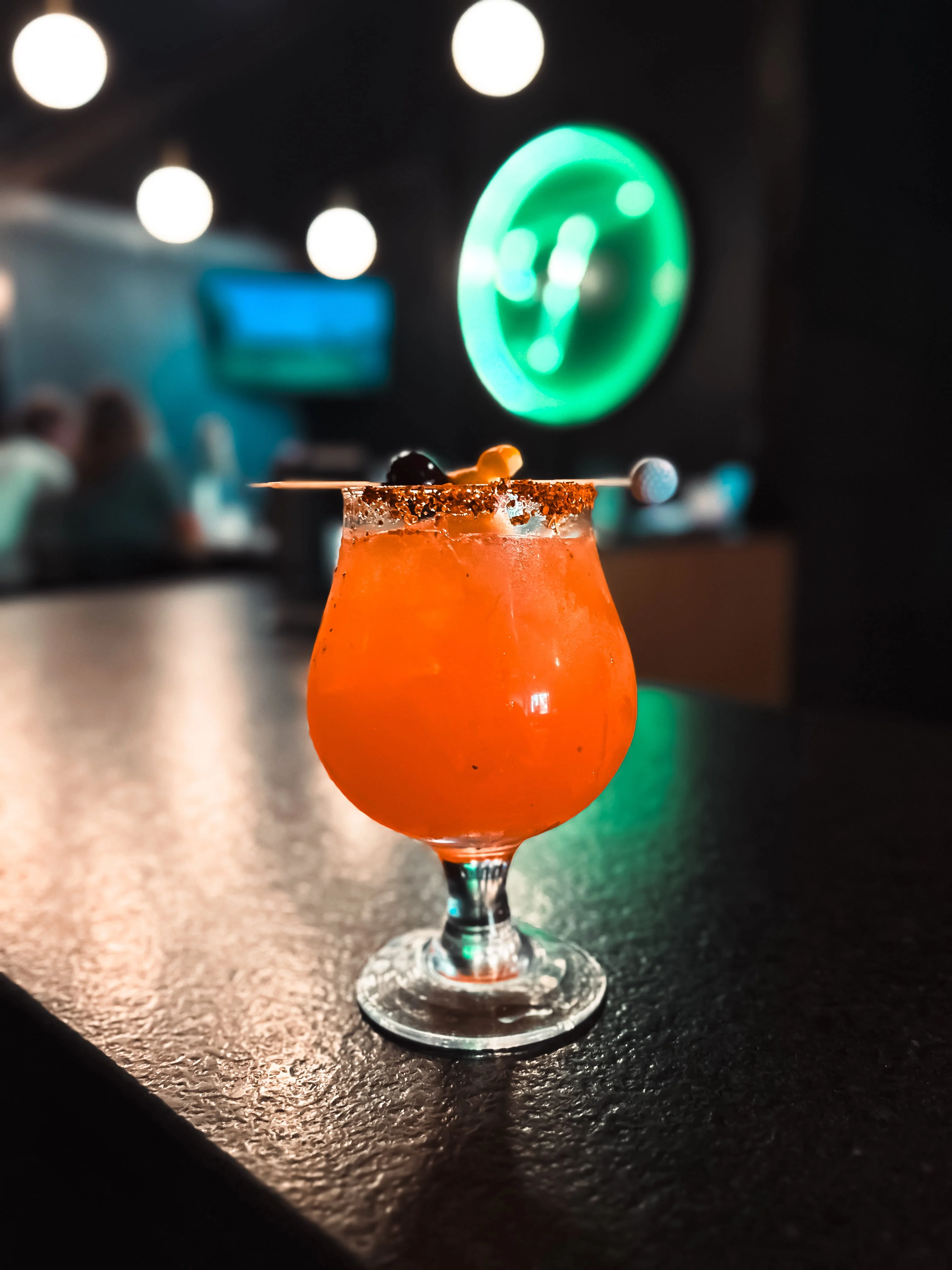 A tray with three colorful drinks in a vibrant setting.