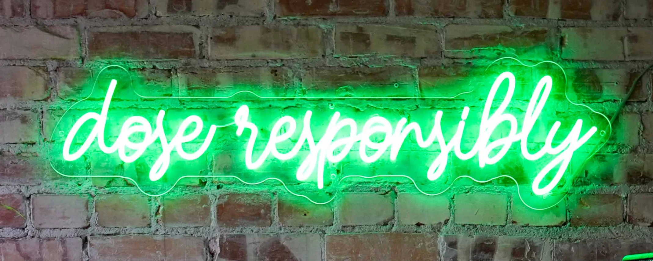 Glowing neon "dose responsibly" sign