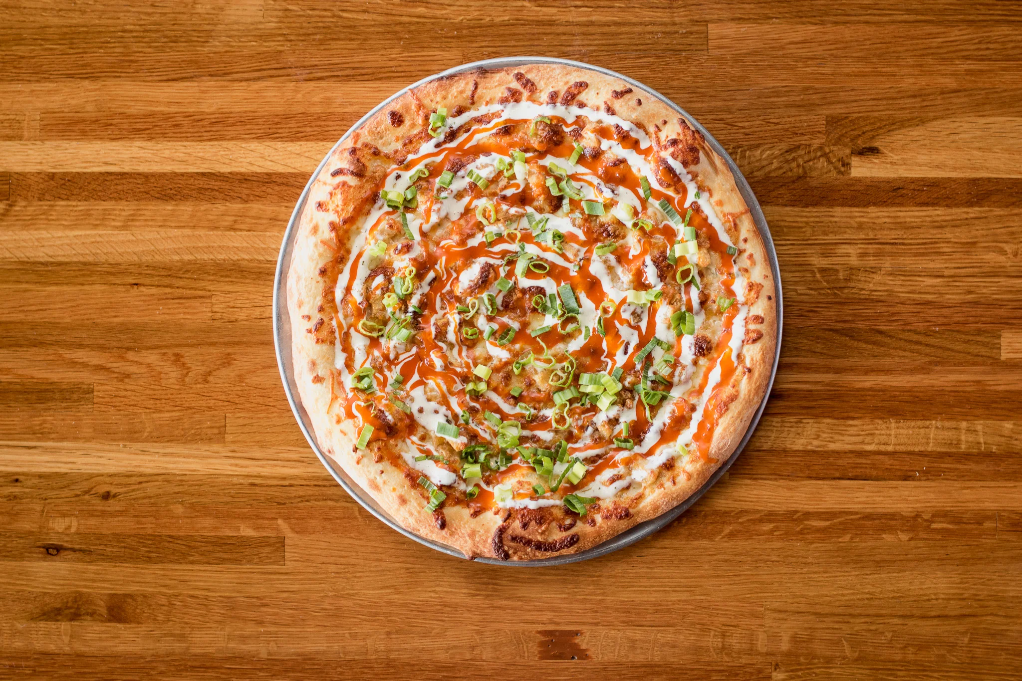 Buffalo chicken pizza with ranch and green onions
