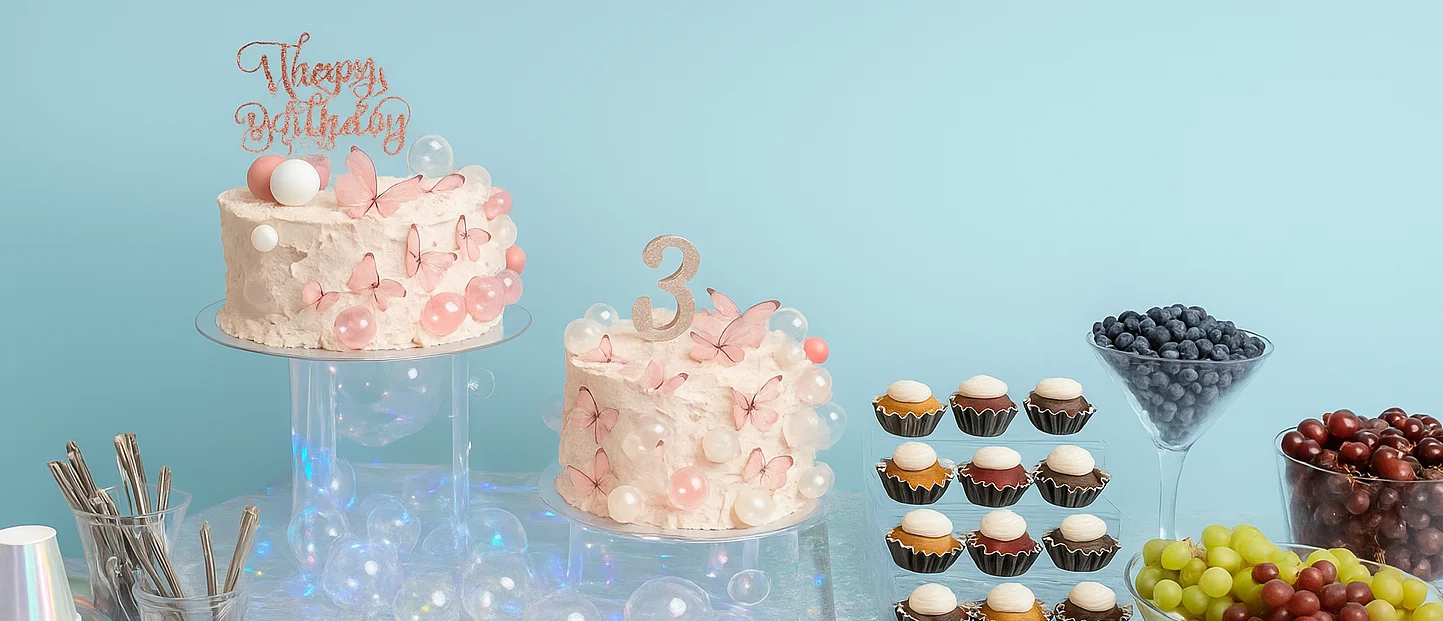 Colorful birthday dessert table with cakes and fruits