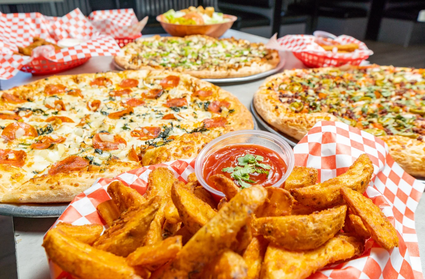 Pizzas and Pepz Potatoes for a group table at Stadium Pepz Pizza & Eatery in Anaheim