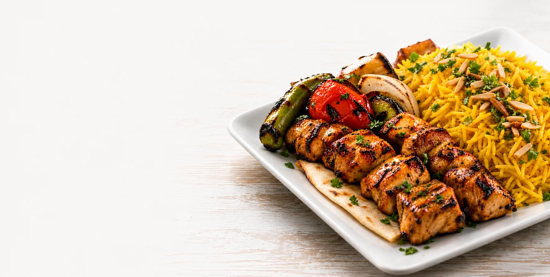 Grilled chicken kebabs with saffron rice and vegetables