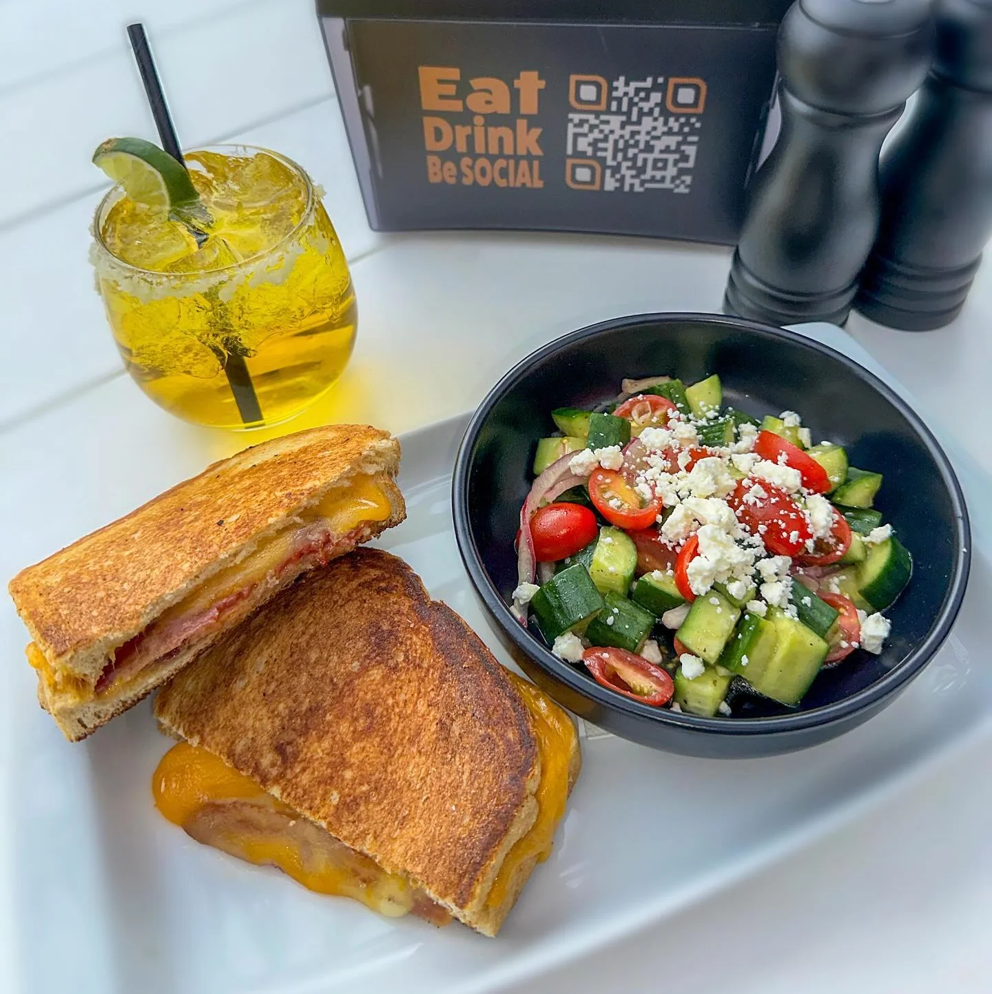 Grilled cheese sandwich with salad and cocktail