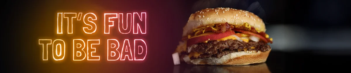steaming hot bad brgr hamburger with tomato, onion and cheese next to the phrase "it's fun to be bad"
