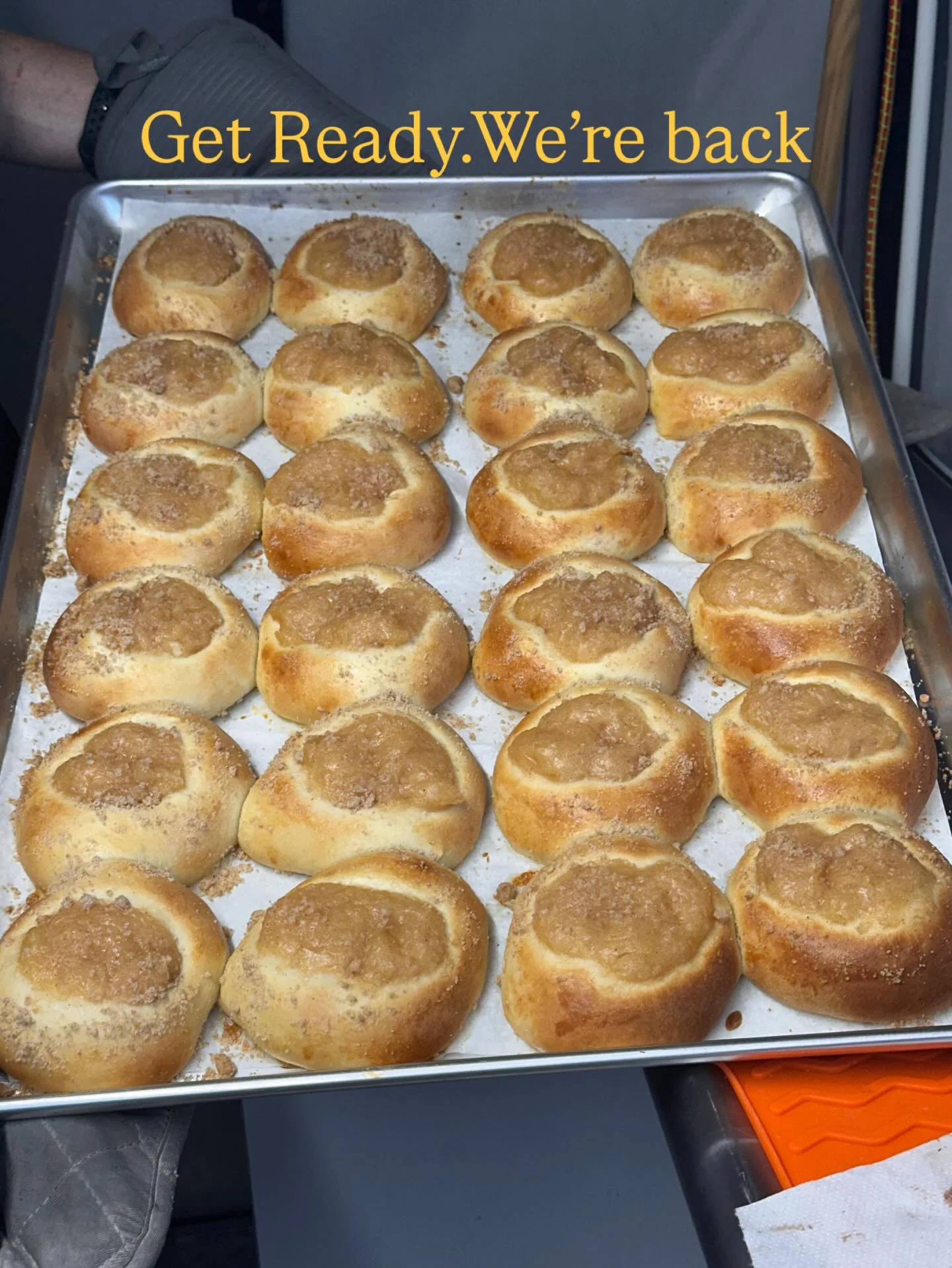 Freshly baked kolaczki pastries on a tray
