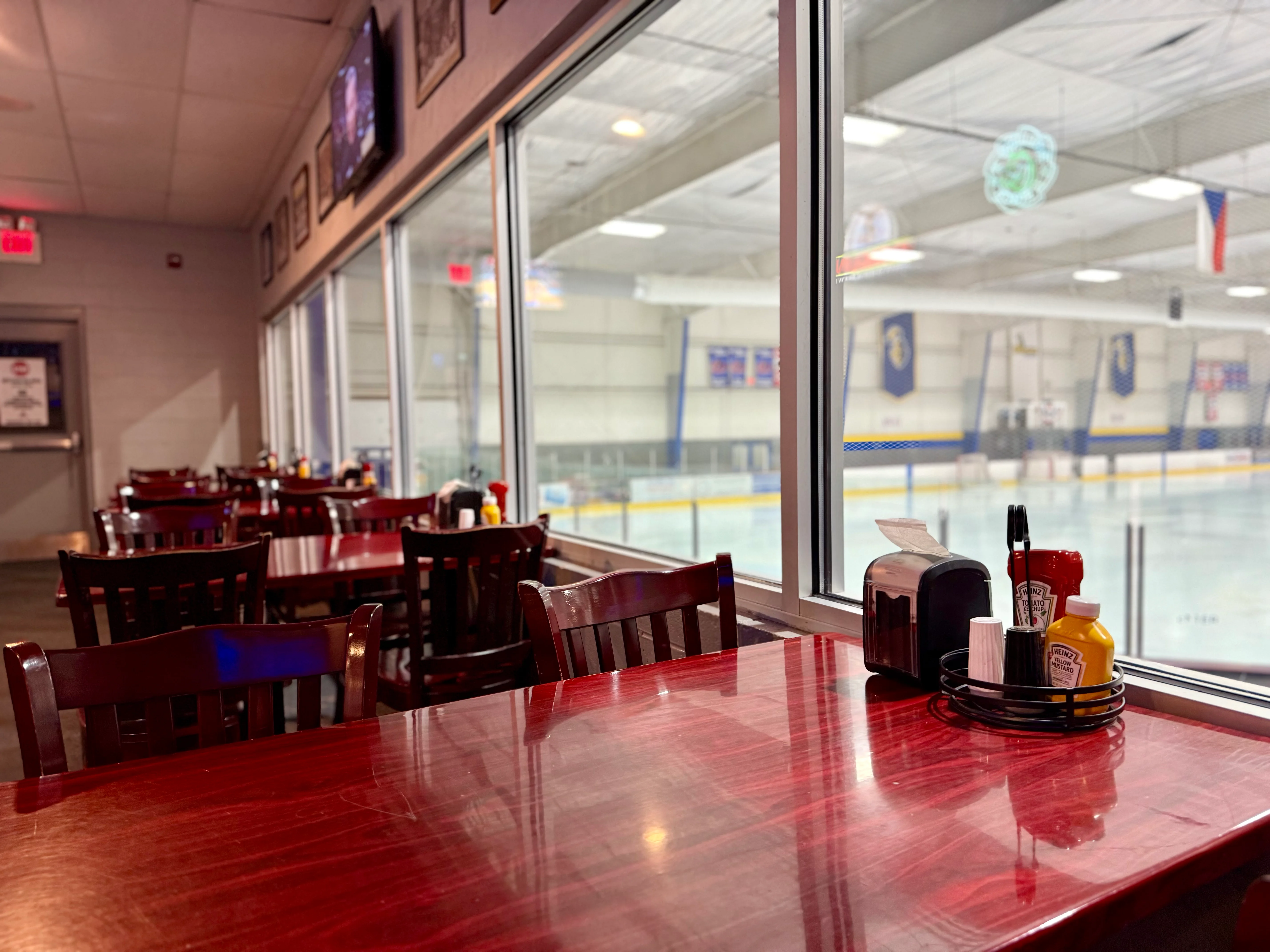 Cozy restaurant interior with views of an ice rink