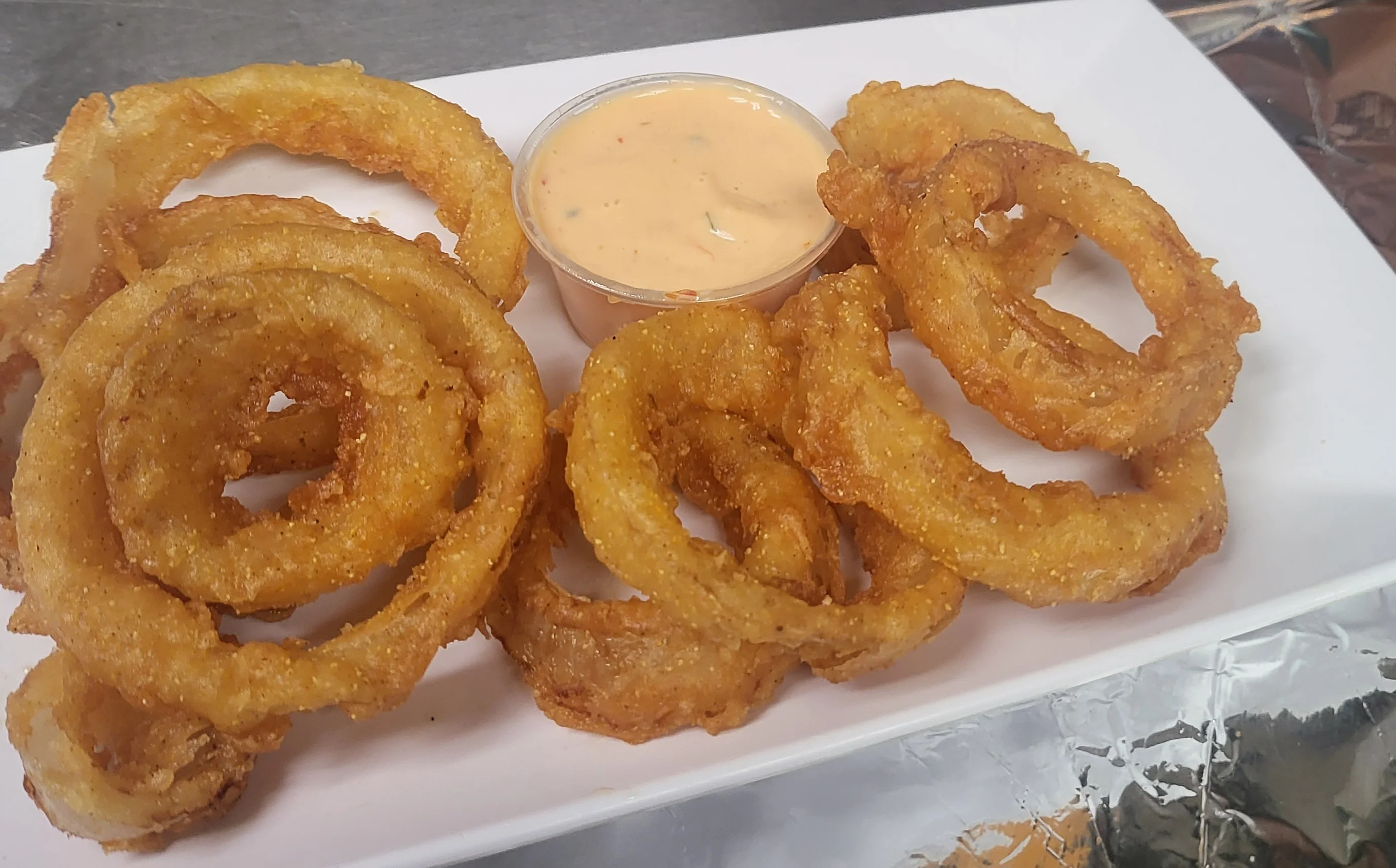 Crispy onion rings served with dipping sauce