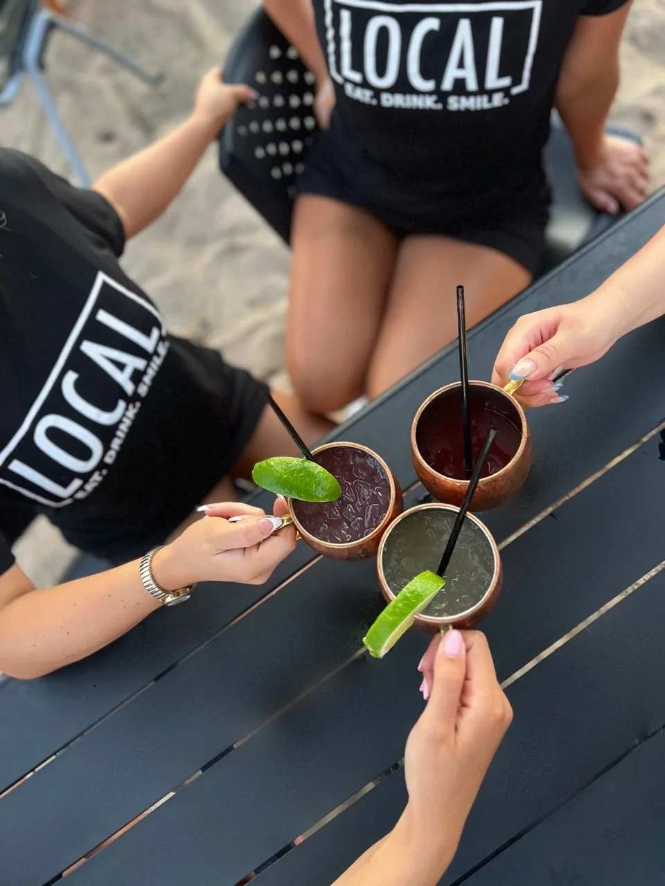 Top photo of staff members holding drinks with limes
