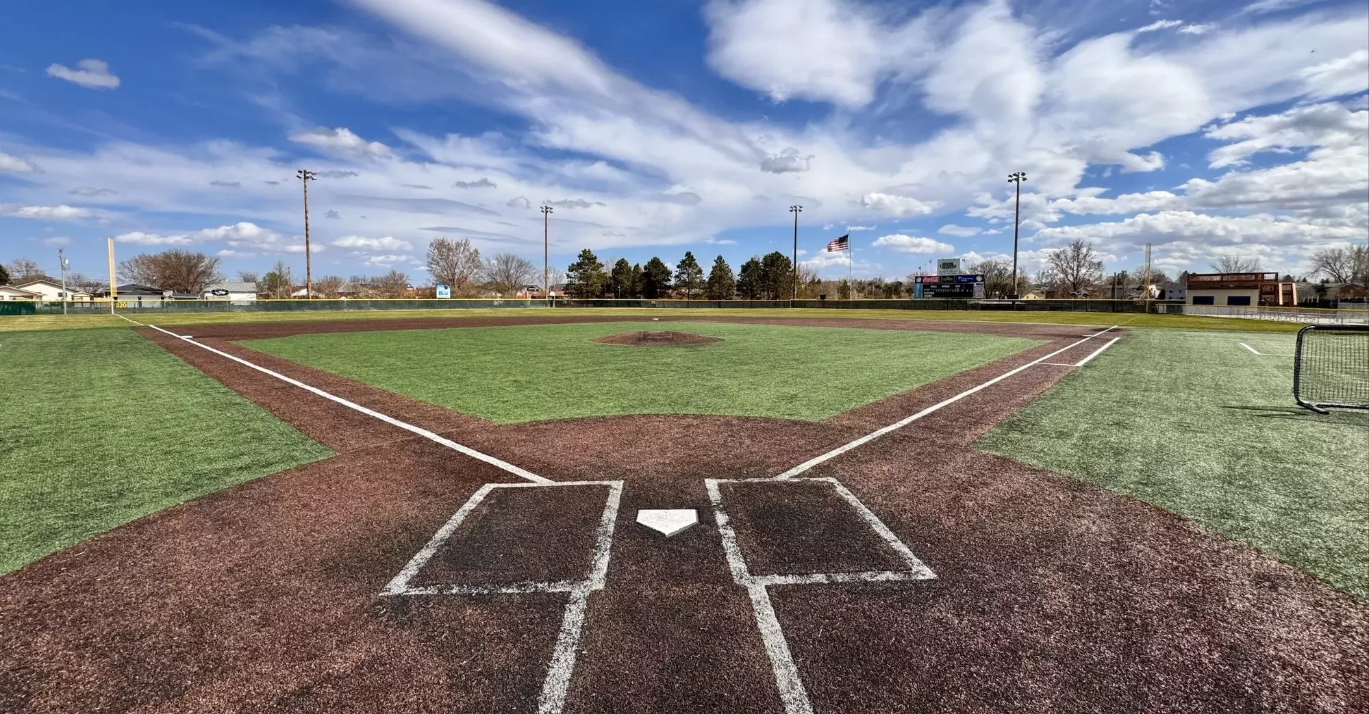 Baseball field under a blue sky with clouds
