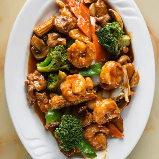 Chinese shrimp and vegetable stir-fry on a white plate