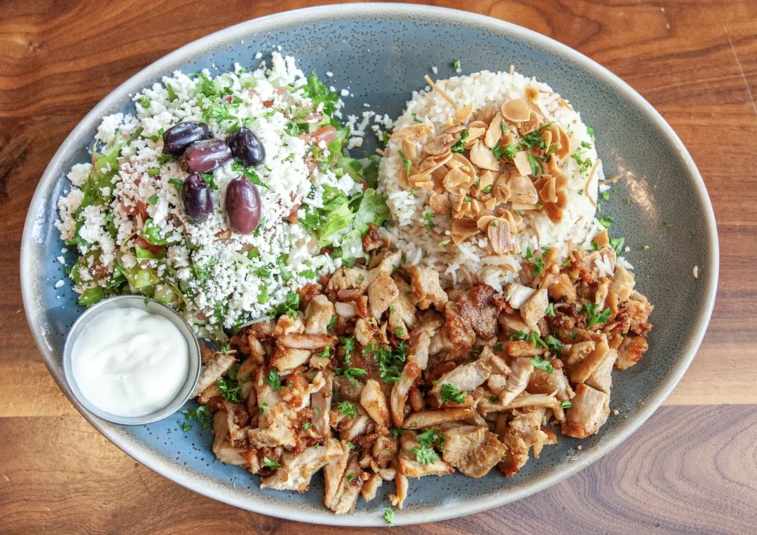 Delicious shawarma platter with fresh vegetables and sauces