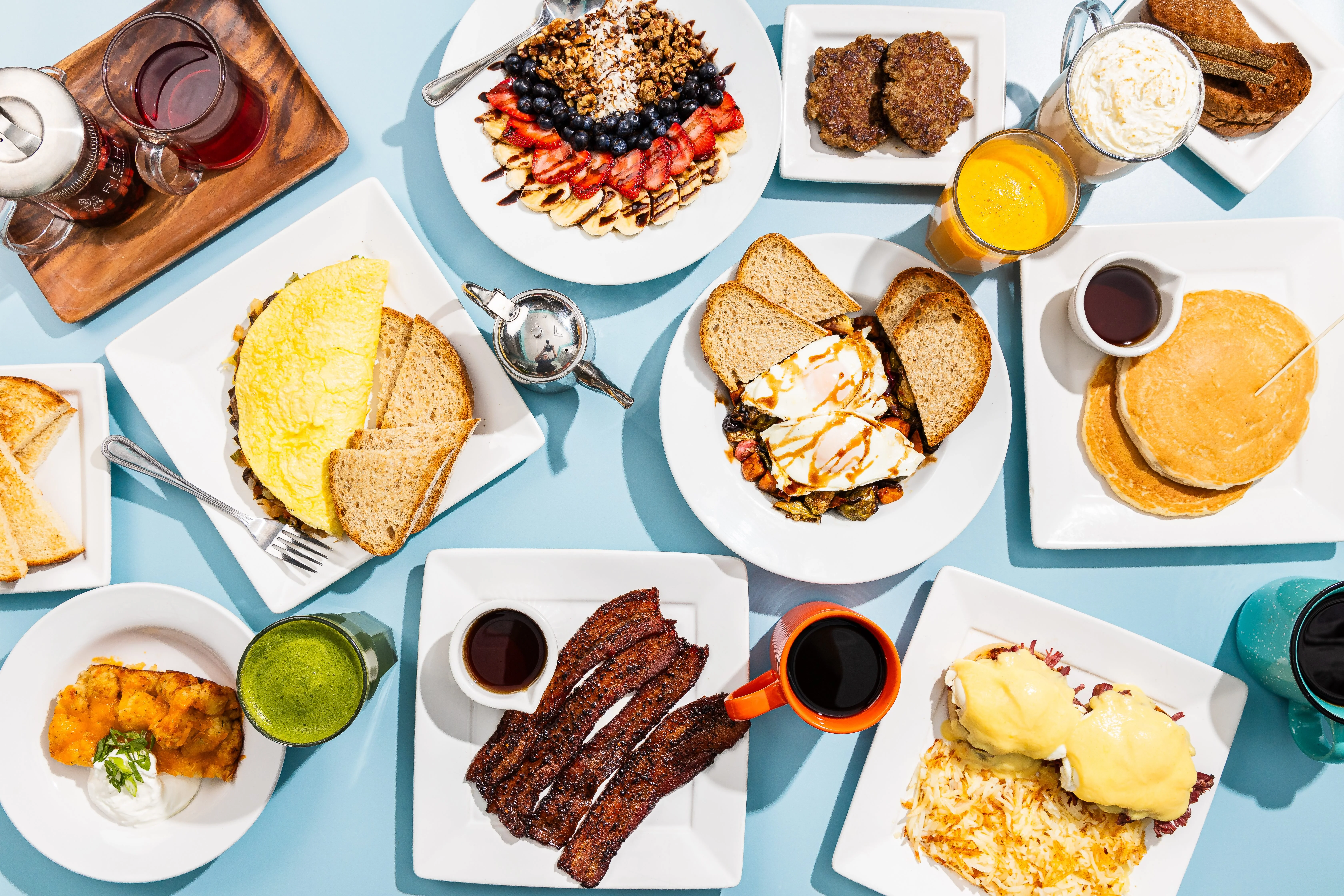Variety of brunch dishes including avocado toast and breakfast burrito