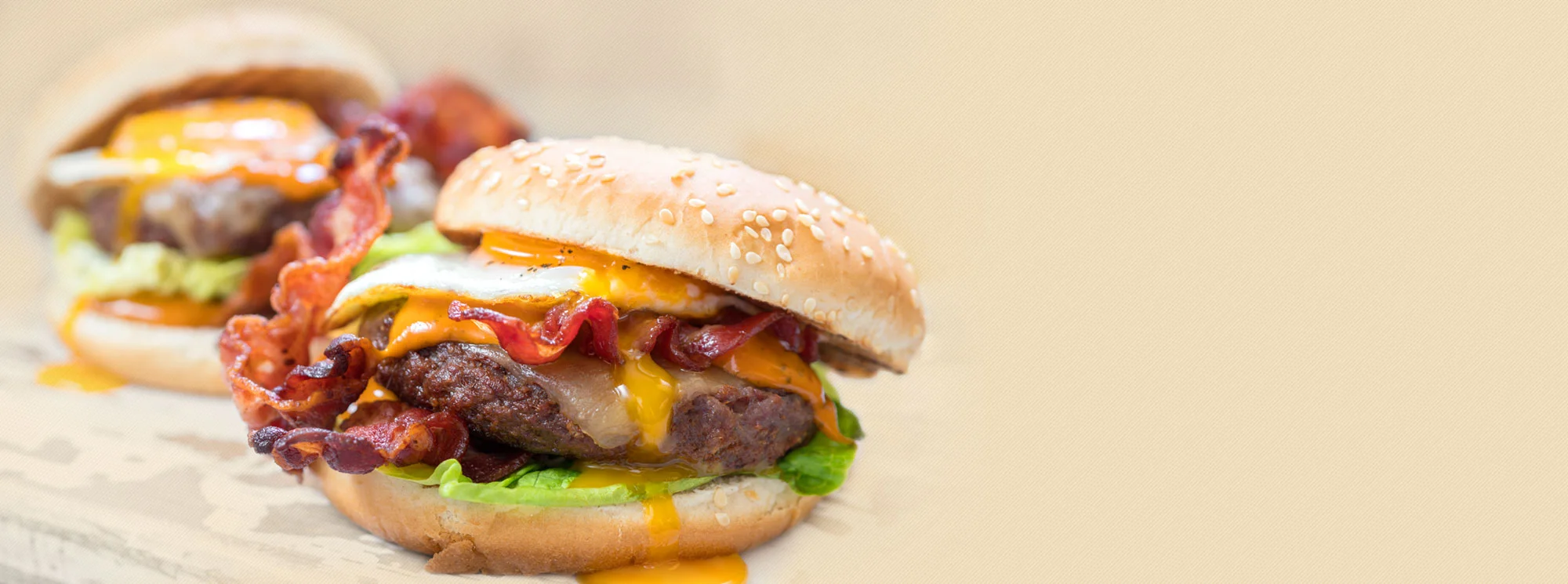Juicy American cheeseburgers with bacon and egg