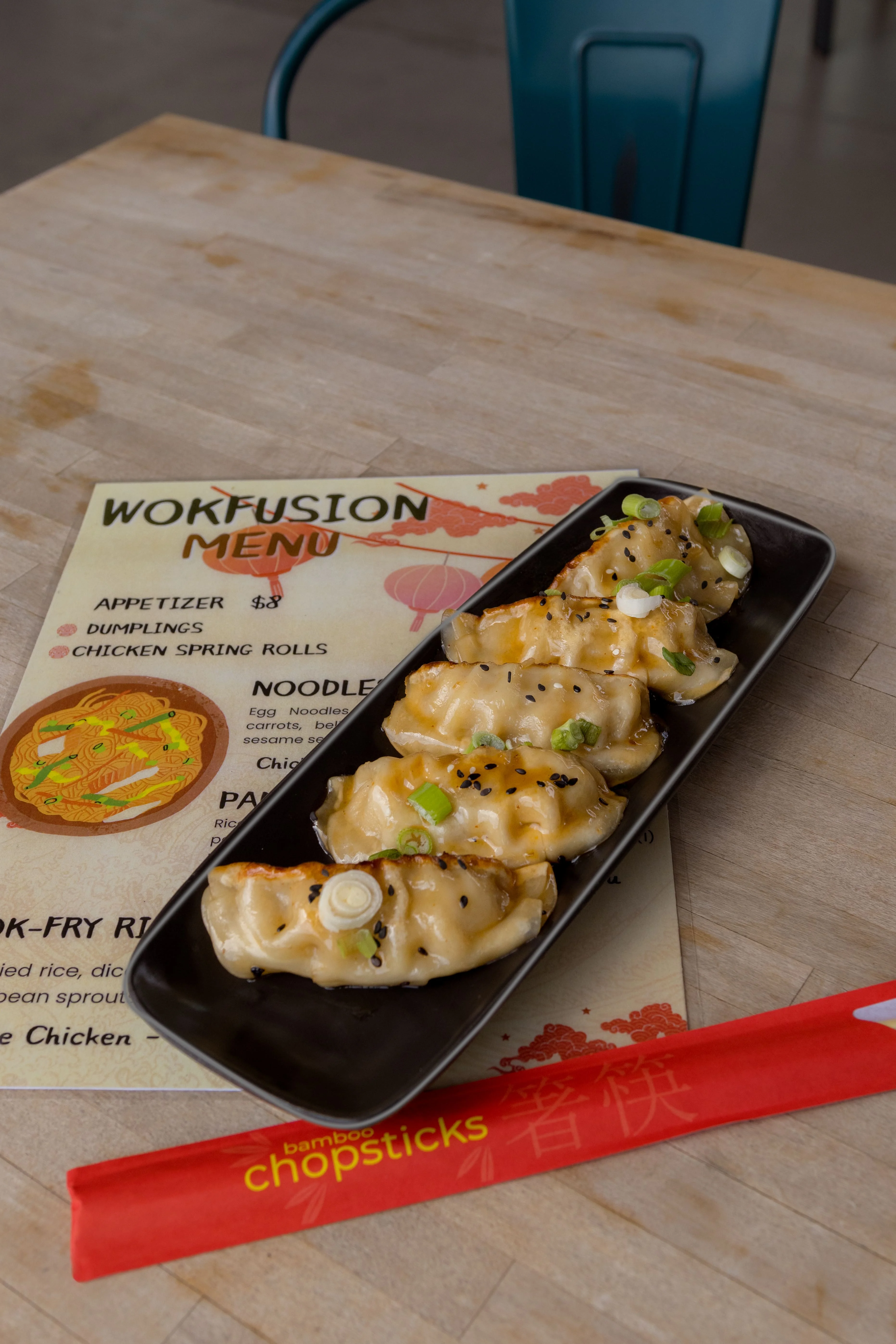 Plate of Japanese gyoza dumplings with dipping sauce