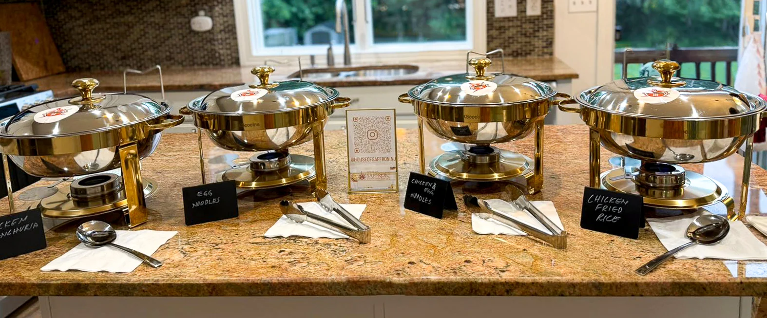 Buffet setup with chicken Manchurian and egg noodles